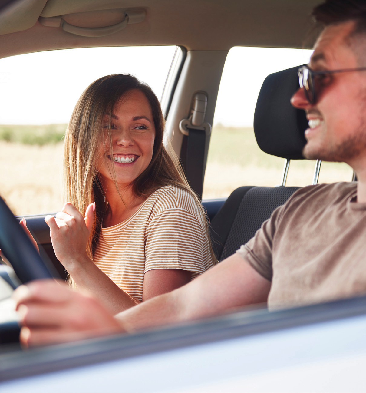 Couple smiling while driving